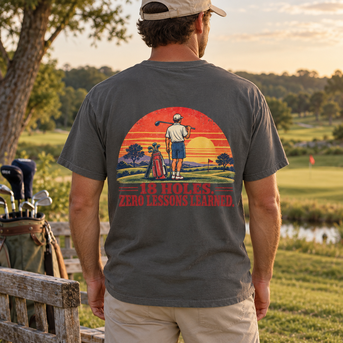 18 Holes. Zero Lessons Learned. tee in Pepper, back print shown on a model in a golf-course lifestyle mockup