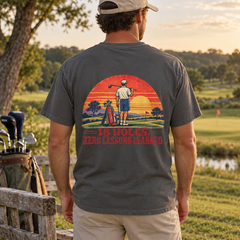 18 Holes. Zero Lessons Learned. tee in Pepper, back print shown on a model in a golf-course lifestyle mockup
